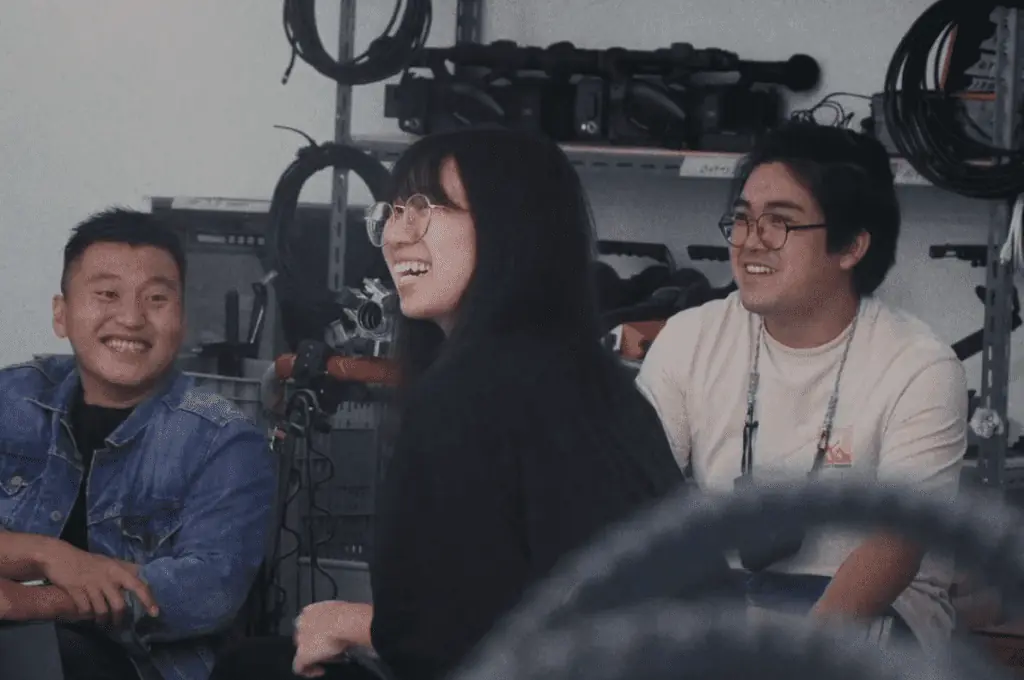 Smiling employees of Vicinity Studio, Video Production Company in Singapore, during a briefing session