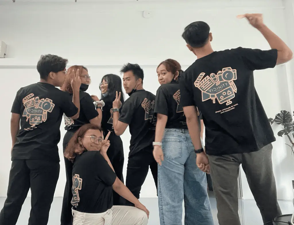 Gen Z Personnels flaunting shirts highlighting Vicinity Studio, a video production company in Singapore